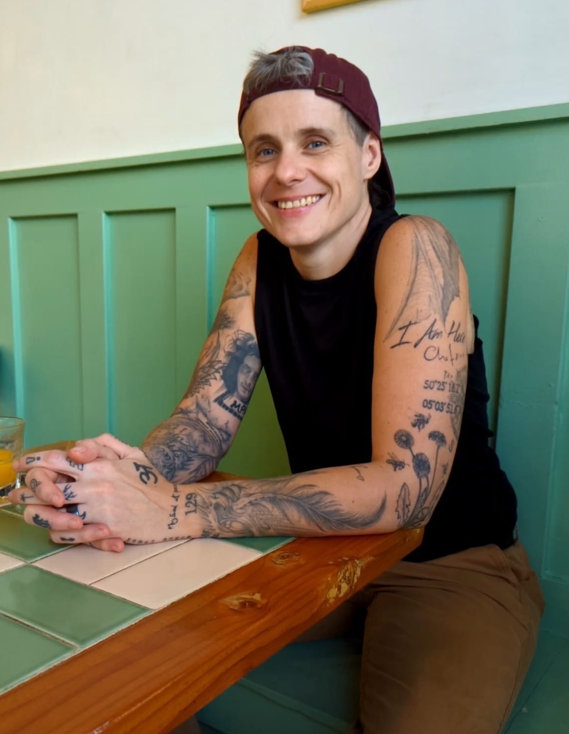 Blake sitting at a café table, smiling